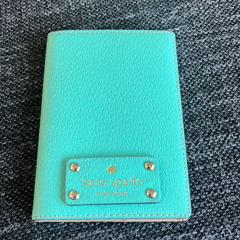 Kate Spade passport holder. Color is teal with silver hardware.